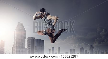 B-boy performing some moves . Mixed media