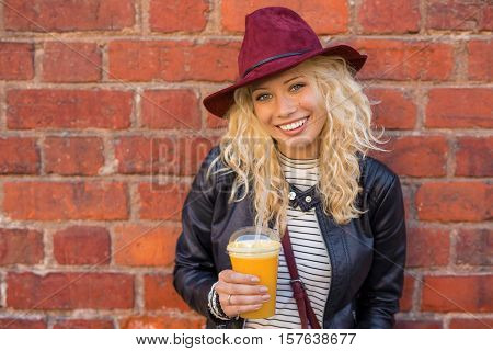 Healthy woman with cup of orange juice in her hands