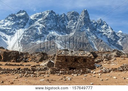 Shed Built Of Stones In High Himalayan Mountains. House In Snowy Mountains On Everest Base Camp Trek