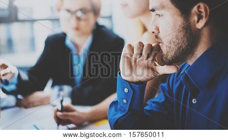 Portrait of pensive hispanic businessman on the business meeting with partners in modern office.Horizontal, blurred background