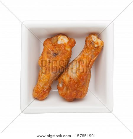 Fried chicken drumettes in a square bowl isolated on white background