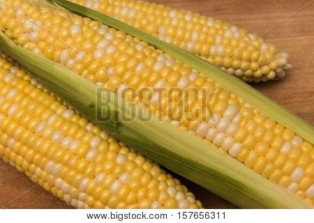 Corn on the cob on a wooden background