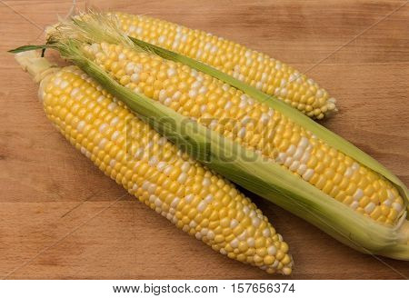 Corn on the cob on a wooden background