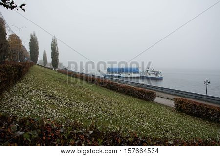City embankment of the river and the mist over the river. Berth ships.