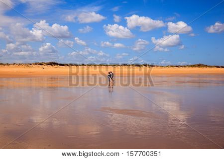 SANTANDER SPAIN - AUGUST 20: Couple walking on the El Puntal beach in Somo on August 20 2016