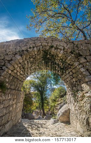 Old stone bridge and blue sky in Risan, Montenegro