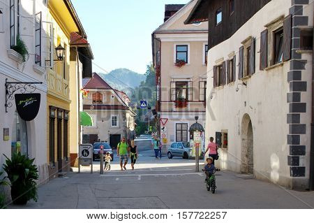 Gmina Škofja Loka, Škofja Loka Slovenia - September 25 2016: old town, Mestni trg (City Square). Typical buildings, windows decorated with flowers. Some people are on the street.