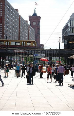 BERLIN, GERMANY - MAY 10: The busy and well-known Alexander square at the Red Town Hall as well as the red town hall passage with pedestrians and passersby in nice weather on May 10, 2016 in Berlin.