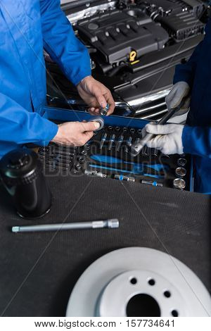 One more workign day. Top view of the table with tools where professional mechanics putting them n order while workign in auto service center