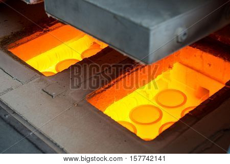 molting gold in a stove at a factory