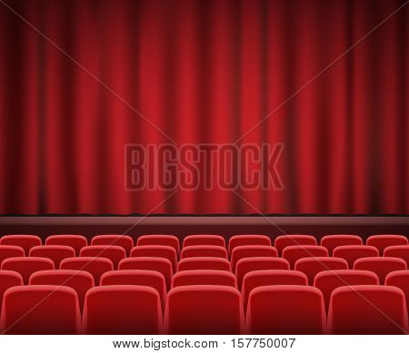 Rows of red cinema or theater seats in front of show stage
