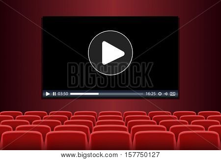 Rows of red seats in front of multimedia playing on a screen