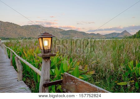 the lamp on the wood bridge go to the lake and mountain