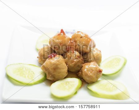 Pork balls with cucumber on the dish.