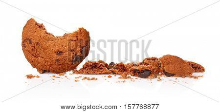 Tasty cookie with chocolate chips and crumbs on white background