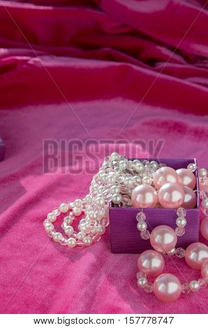 From The Purple Boxes Hanging Pink Pearl Strands  Из лиловой коробки висят розовые жемчужные нити