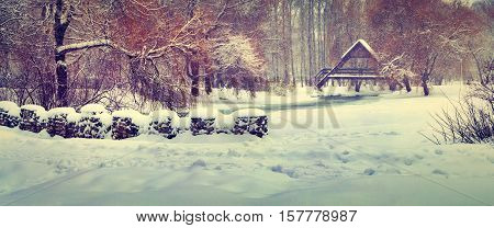 Panorama of the first snowfall in the city park. Retro style.