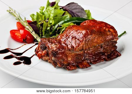 roasted pork ribs on a white plare