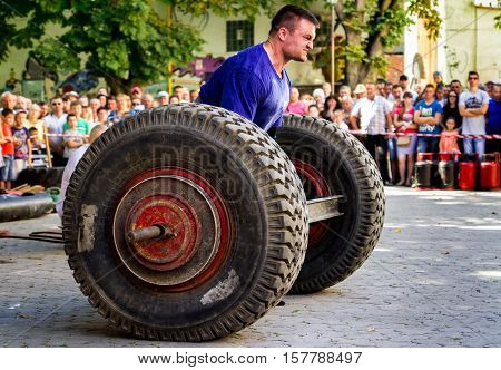 Uzhgorod Ukraine - August 28 2016: Strongmen perform exercise during the 13th power tournament 