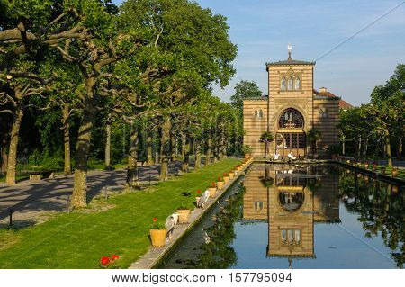 Stuttgart Germany - MAI 13 2015: the Zoo Wilhelma in Stuttgart. Artificial pond with aquatic plants. Ancient palace in the background.