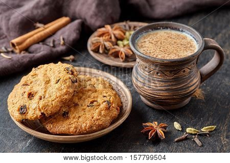 Masala pulled tea chai latte traditional hot Indian sweet milk spiced drink, ginger, cinammon fresh spices blend, anise organic infusion healthy wellness beverage teatime ceremony in rustic clay cup