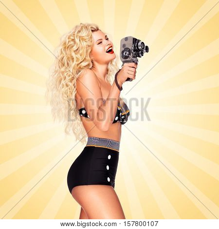 Pin-up girl shooting a movie with an old cinema 8 mm camera on cartoon style background.