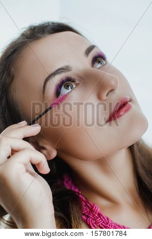 Girl with beautiful purple eyelash comb , eye , beautiful makeup, fashion face