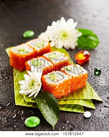 California Maki Sushi with Masago - Roll made of Crab Meat, Avocado, Cucumber, Japanese Mayonnaise inside. Masago (smelt roe) outside