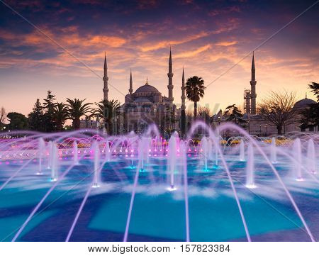 Colorful Spring Sunset In Sultan Ahmet Park In Istanbul, Turkey, Europe. Colorful Fountain On The Ba