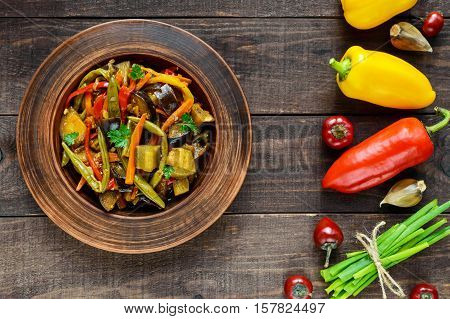 Vegetable stew (salad): bell pepper eggplant asparagus beans garlic carrot leek. Bright spicy aromatic dishes. Menu of Italian cuisine. The top view.