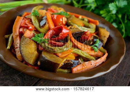 Vegetable stew (salad): bell pepper eggplant asparagus beans garlic carrot leek. Bright spicy aromatic dishes. Menu of Italian cuisine.