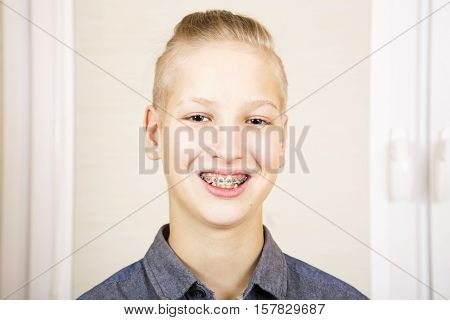 Teen with braces on his teeth. Orthodontics and bite correction.