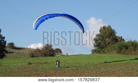 ROCCA PRIORA ITALY - NOVEMBER 1 2016: paragliding lesson a paraglider landing after a training flight
