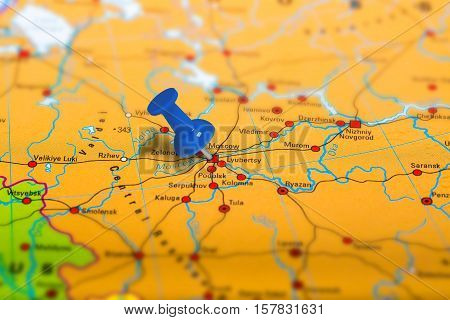 Moscow in Russia pinned on colorful political map of Europe. Geopolitical school atlas. Tilt shift effect.