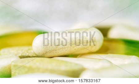 Mixed natural food supplement pills omega 3 multivitamin and glucosamine capsules macro image