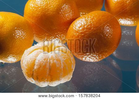 Tangarines and reflections with a blue background