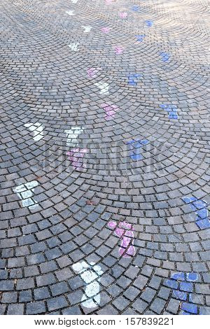 paint feet steps on cubical stone - leading away concept
