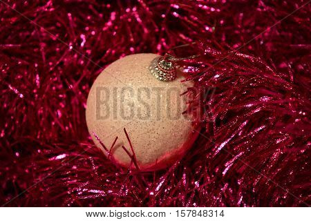 Photo by beautiful silver christmas ball in the red tinsel.