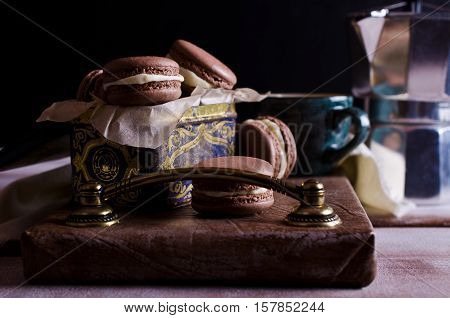 Homemade brown macaroon with white cream. Selective focus.