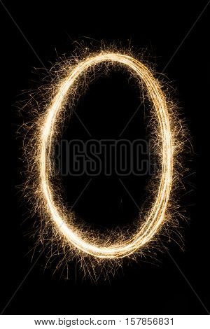 English letter O or null zero number made from burning sparkles on black background. Shiny festive party firework font, latin alphabet text queen sign.