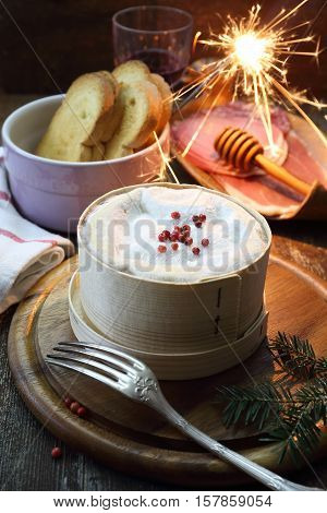 New Year food: French Vacherin Mont d'Or cheese cold cuts and red wine