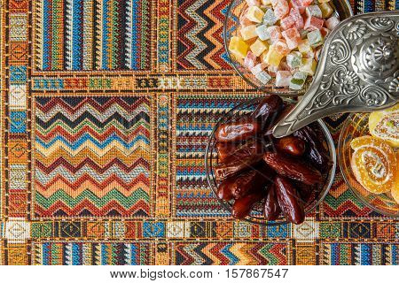 sweets and dates on a traditional Arabian tablecloths