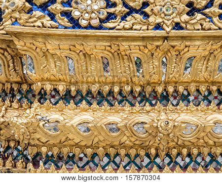 Gloden flower pattern with glass mosaic on the church wall in the Thai temple. (Public area not required Property Release)
