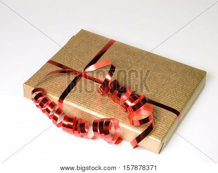 Present wrapped in gold with red bow