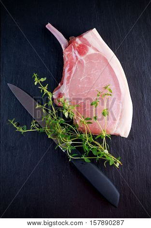 Top view Raw pork cutlet close up. on stone background.