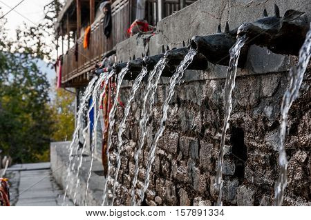 Wall fountain, water flowing through animal shaped pipes. Muktinath.