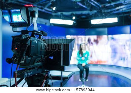 Closeup of a Video Camera Filming a TV Host
