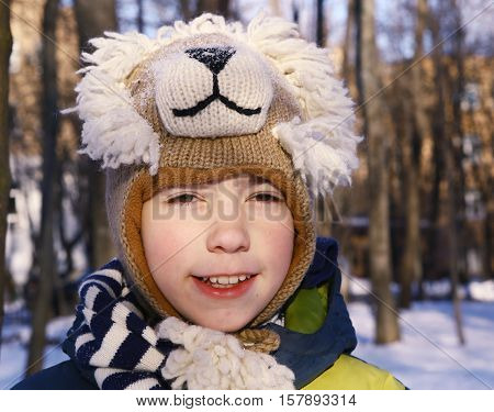preteen handsome boy in funny lion hat close up portrait