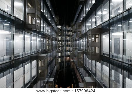 Beautiful illuminated windows of modern building at dark night in city