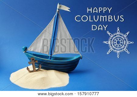 Text HAPPY COLUMBUS DAY with wooden boat on blue background. National holiday concept.